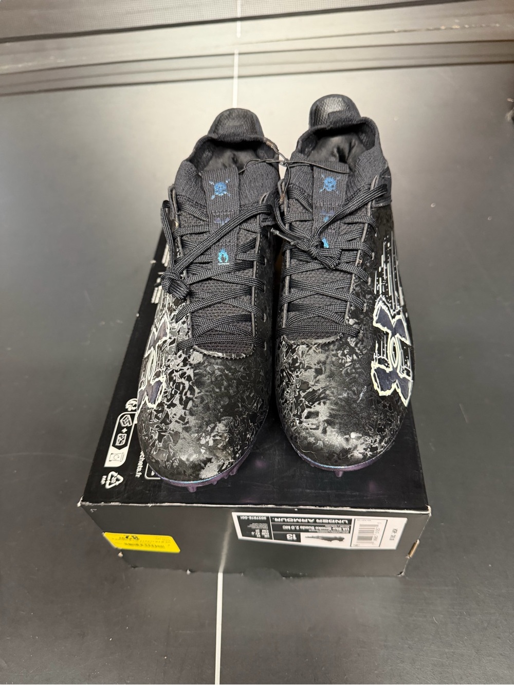 Under Armour Men’s Black cleats with Subtle Blue Details Blur Smoke Suede 2.0